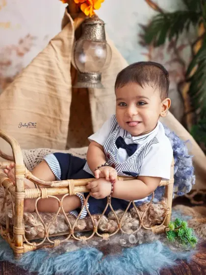 A big, happy smile from this little camper. The combination of the rustic props and his smart outfit makes for an absolutely adorable milestone photo.