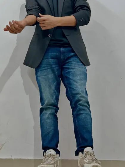 A full-length shot showing how style and posture come together. Confidence is projected from head to toe.