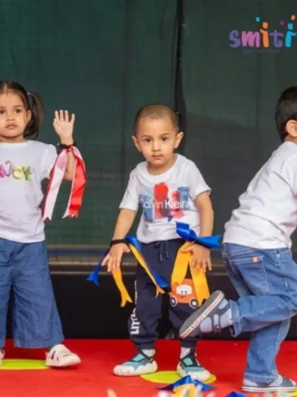 Children strike a pose during their energetic dance number. Movement and play are central to our educational philosophy.