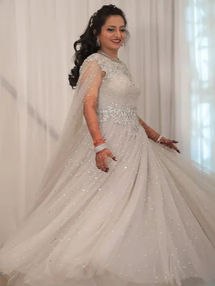 Another shot of the client in the silver-white gown, showing its sparkle and movement.