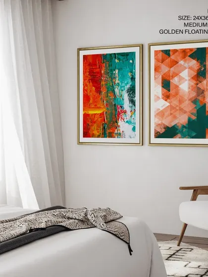 A vibrant set of two abstract prints, one with textured brushstrokes and the other with a geometric pattern. The complementary orange and teal color scheme, enhanced by golden floating frames, creates a cohesive and energetic look.