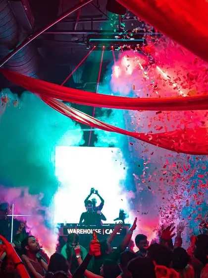 A silhouette against a backdrop of colorful smoke and confetti. This is the kind of high-energy, visually rich environment I create.