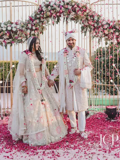 A classic portrait of the couple at their mandap after the ceremony.