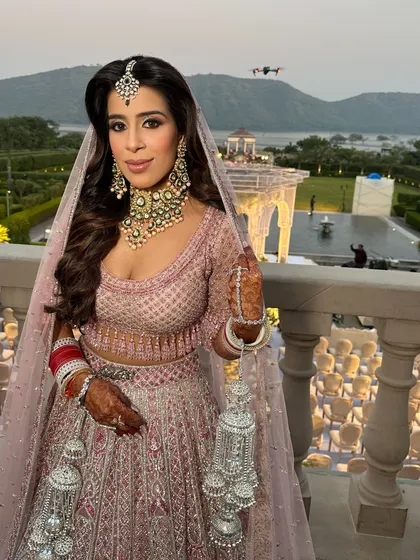 A closer look at her wedding day ensemble. The makeup features soft, shimmery eyes and a neutral pink lip, creating a romantic and timeless bridal look.