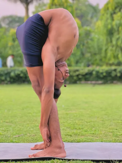 Bend, bend, more bend. This intense forward fold, a variation of Dimbasana, is the result of dedicated practice and learning to release tension.