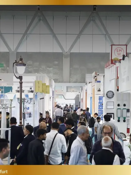 The aisles are filled with curious visitors exploring a diverse range of lighting products, from commercial to decorative.