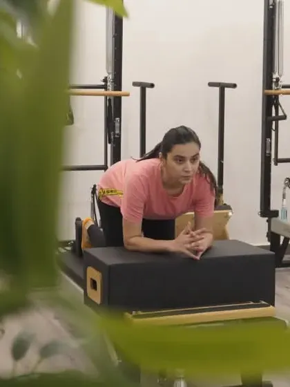A quiet moment of focus. This client is preparing for a knee stretch series on the reformer box.