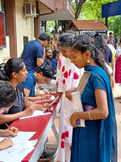 Our volunteers at the registration desk, focused and ready to help. Their dedication is the backbone of our ability to support large-scale community events.