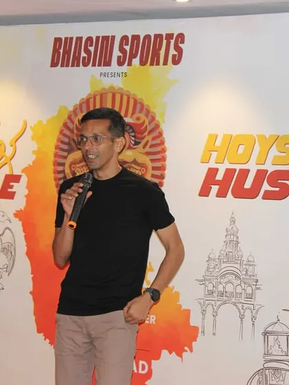 An experienced runner from the community speaking at our launch event. We value the insights and participation of veteran runners in shaping our races.