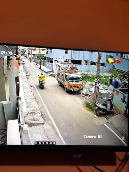 A clear daytime view of the street outside a residence from a 4MP Hikvision IP camera. High resolution is important for capturing details like license plates.