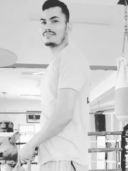 A black and white photo from the boxing gym with a furry friend. A balanced life is important, and I enjoy every moment.