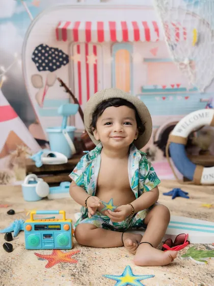 A sweet moment holding a starfish prop during his beach-themed session.