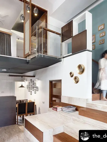 The "Grilled Sandwich House" features two duplex units stacked together. This interior shot shows the split-level design, which creates interesting volumes and visual connections between different living areas.