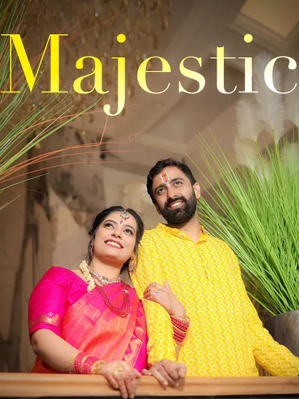 A beautiful, upward-looking shot of Kishi and Aaditya, capturing their joy and the grandeur of their surroundings.