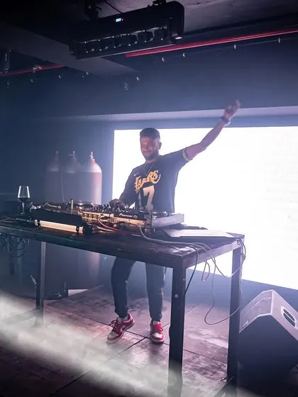 A full shot of me on stage at Cyclone Club, illuminated by a single beam of light.