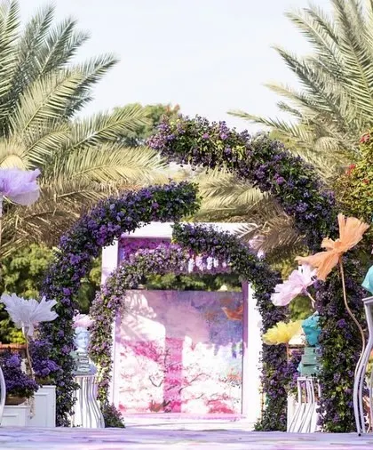 Whimsical decor elements for a unique Haldi ceremony, including floral arches, colorful deer statues, and artistic busts, all in a cohesive pastel color scheme.