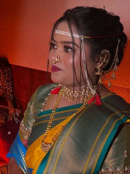 A profile shot of the bride, showcasing her elegant hairstyle and the dramatic lighting.