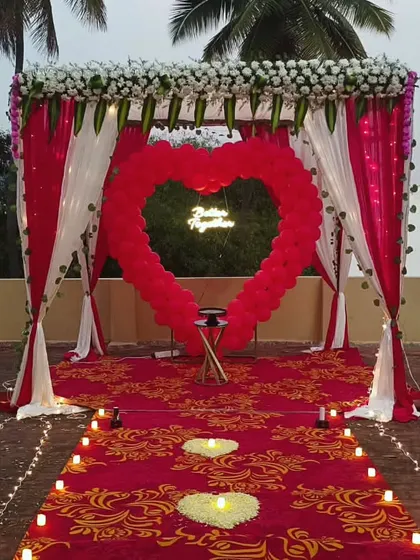 A full view of the proposal decoration. The candle-lit path leading to the heart-shaped arch creates a truly magical and romantic moment.