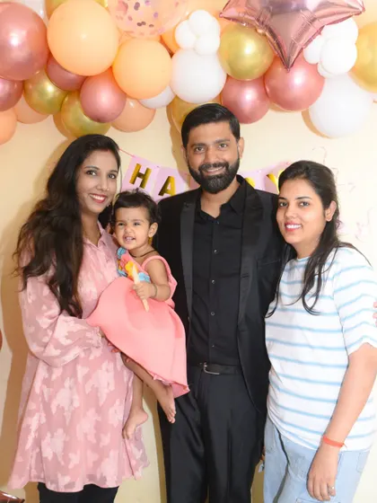 A sweet group photo with the smiling birthday girl at the center of attention.
