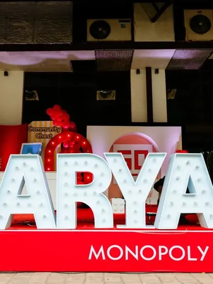 Giant marquee letters spelling out the birthday boy's name, "AARYAN," served as a fantastic photo backdrop and a central piece of decor for his Monopoly-themed party.