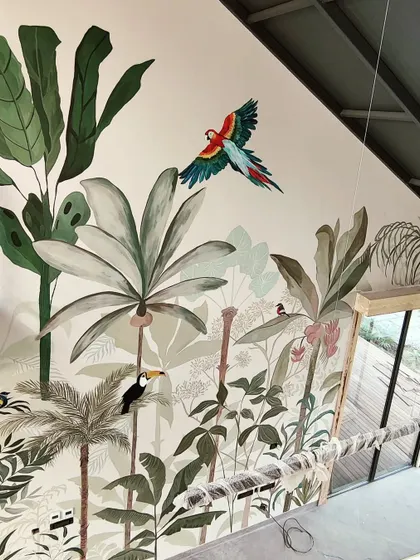An angled shot of the rainforest mural, highlighting the vibrant parrot at the top which acts as a colorful showstopper.