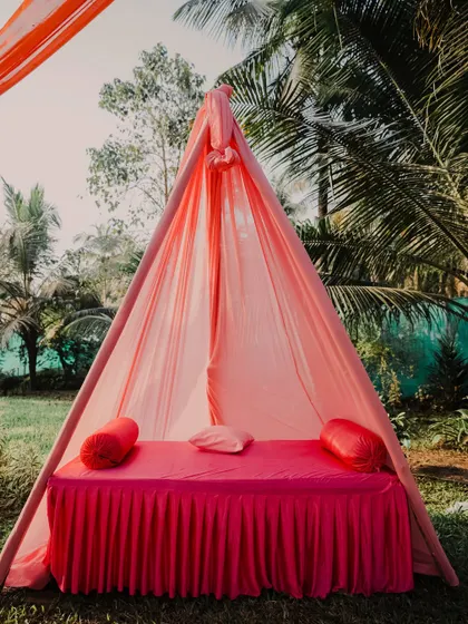 A cozy and colorful teepee-style seating arrangement, perfect for a relaxed and stylish Mehendi or Haldi function.
