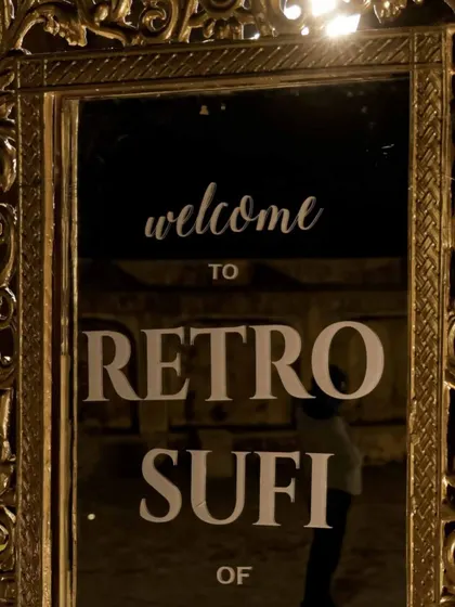 A welcome sign for the 'Retro Sufi' night, elegantly displayed on an ornate golden mirror.