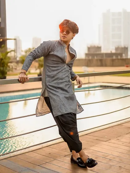 A profile shot that highlights the outfit against the modern city backdrop.