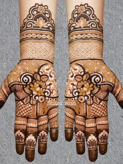 A symmetrical design with a central lotus cluster, surrounded by intricate patterns and a traditional cuff.