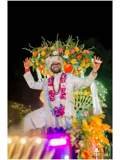 The groom's joyful entrance on a floral carriage.