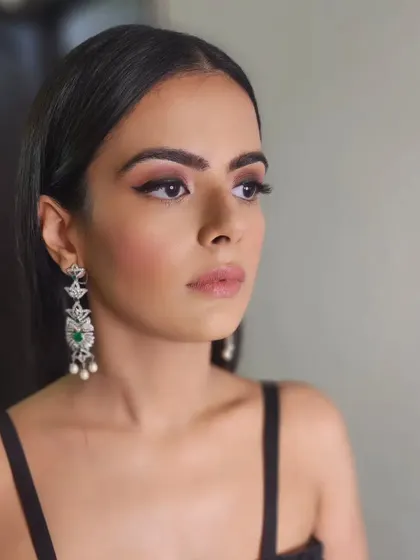 Beauty in black. This minimalist look features a classic winged eyeliner and soft, glowing skin, creating a timeless and sophisticated style for a night out.