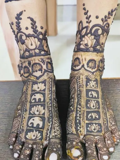 Don't forget the feet! This bridal foot mehndi features rows of marching elephants and delicate floral patterns, ensuring you look stunning from head to toe.