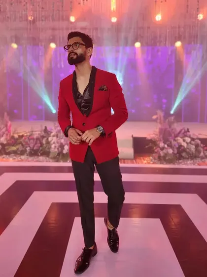 Bringing the fire in a sharp red and black suit. This look is perfect for a high-energy sangeet or a glamorous awards night.