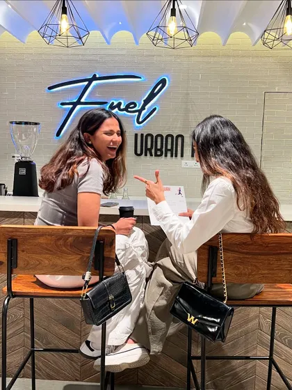 It's not just a gym, it's a social hub. Members catching up and laughing over coffee at our in-house cafe.