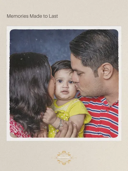 An intimate family moment with parents kissing their baby's cheeks. This studio-quality shot was captured in the comfort of the family's own home.