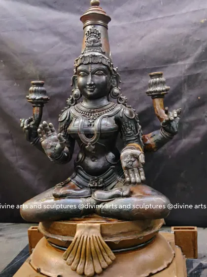 A different angle of the Mahalakshmi wax model, showing the graceful posture and the detailed ornamentation on her crown and jewelry.