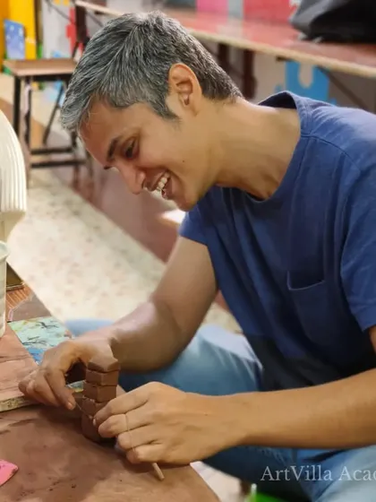 A student carefully works on a small, hand-built project. Our workshops offer a chance to disconnect from daily stress and focus on the mindful process of creating.