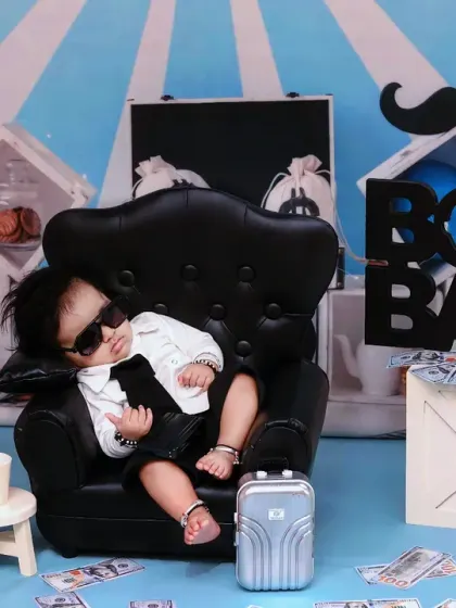This boss baby is taking a well-deserved nap in his executive chair after a long day of meetings.