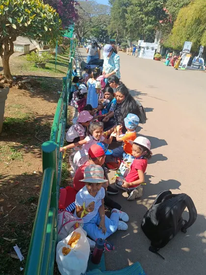 Taking a snack break by the fence at Lalbagh. These simple moments of rest and refueling are an important part of a long and exciting day of exploration.