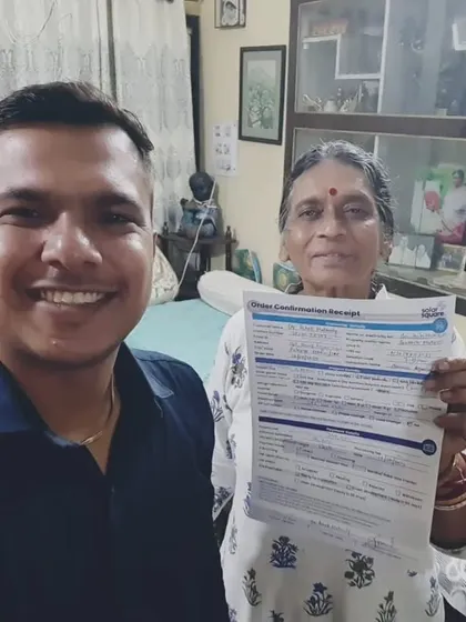 A customer smiles as she receives her solar agreement.