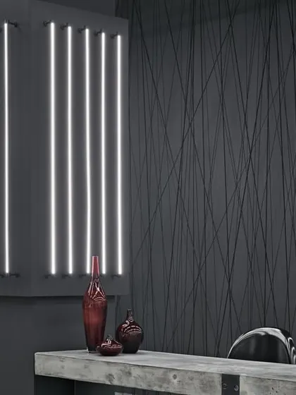 A detail from a fashion showroom where we used raw, industrial materials to create an elegant backdrop. The textured black wall and dramatic lighting highlight the single red garment, turning it into a piece of art.