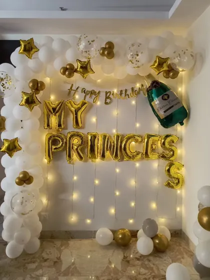 A "My Princess" themed birthday wall decoration. This setup uses gold and white balloons, fairy lights, and foil letters.