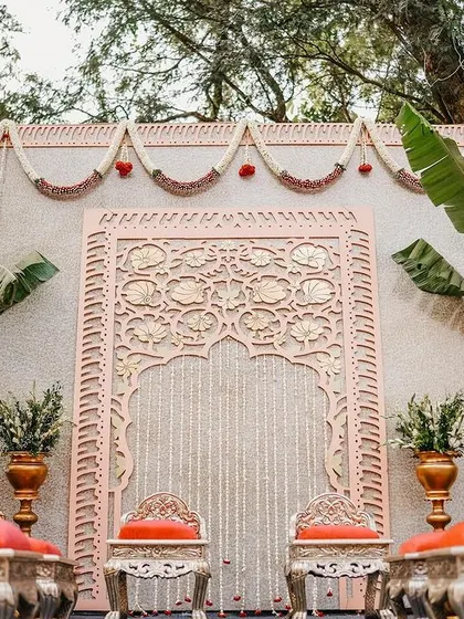 Another angle of the Indo-Western engagement stage, showing the beautiful symmetry of the banana plants and the intricate detail of the carved backdrop.