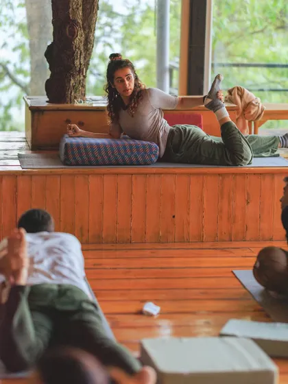 Demonstrating a gentle heart-opening pose from the front of the class. I often use bolsters to make the practice more restorative and accessible.