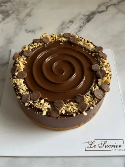 A full view of my Nutella Hazelnut Cheesecake. The glossy Nutella swirl, toasted hazelnuts, and chocolate chips make it as beautiful as it is delicious.