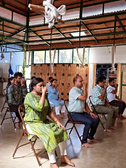Participants at a corporate workshop for Health Heal practice a seated breathing technique. Learning to control the breath is a powerful tool for managing stress during a busy workday.