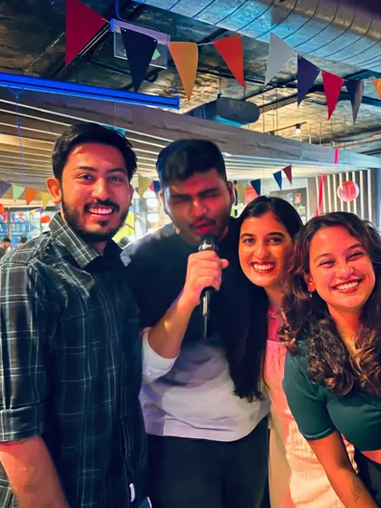A group of friends having the time of their lives at karaoke. It's the perfect way to bond and create lasting memories.