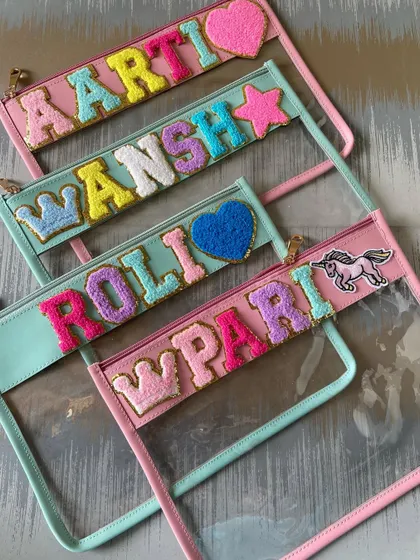 Stash your stuff in style with our trendy clear travel pouches. We use colorful, sparkly chenille letters to spell out your name, making it a fun and practical accessory.