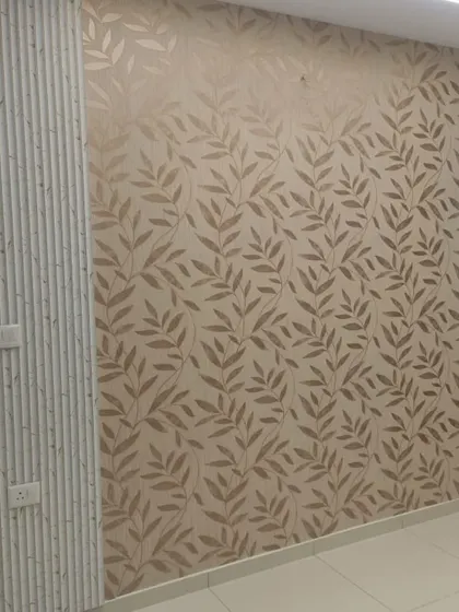 Here, a leaf-patterned wallpaper is used as a central accent, flanked by fluted wall panels. This combination of textures creates a sophisticated and modern look for a living room or bedroom wall.