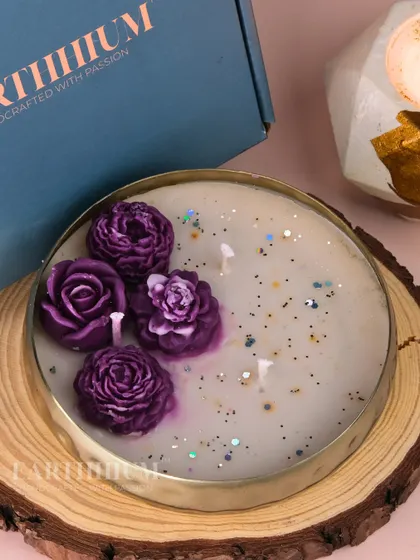 This Urli candle features rich purple roses with a sprinkle of glitter for a touch of magic. The deep color makes it a striking accent piece for any room.